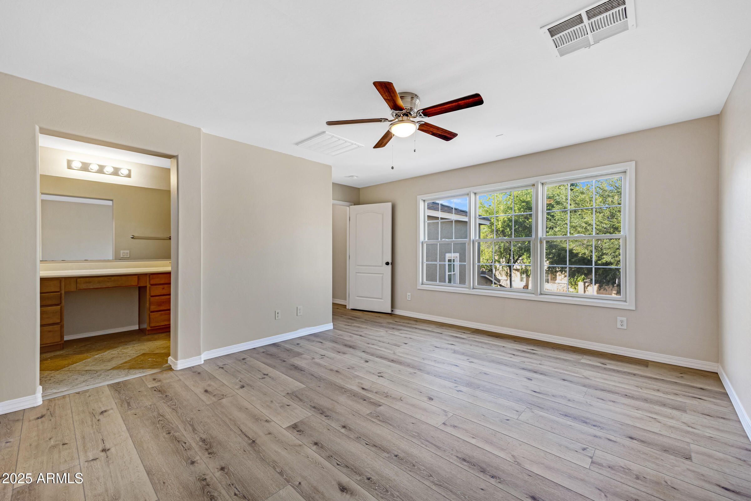2315 East Pecan Road Phoenix, AZ 85040 - Photo 30 of 36 a view of empty room with wooden floor and fan