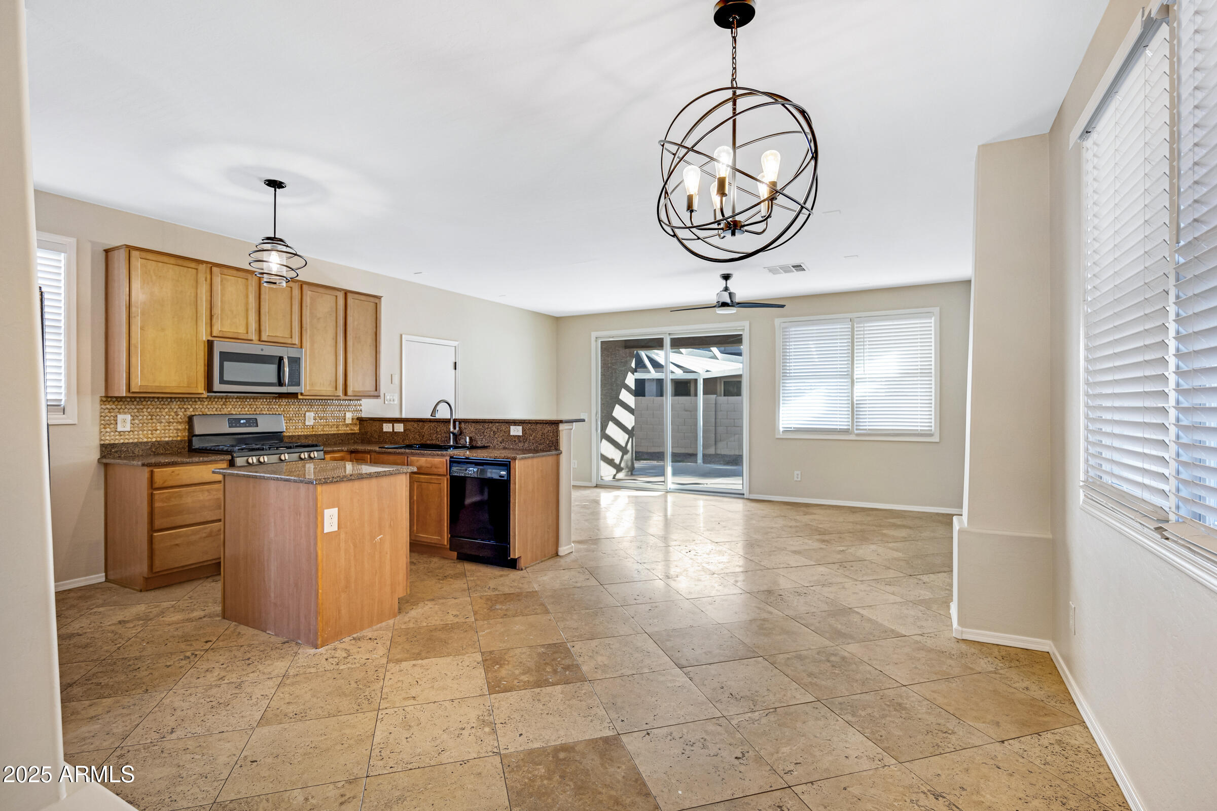 2315 East Pecan Road Phoenix, AZ 85040 - Photo 10 of 36 a kitchen with stainless steel appliances granite countertop a stove a sink a refrigerator dining table and chairs with wooden floor