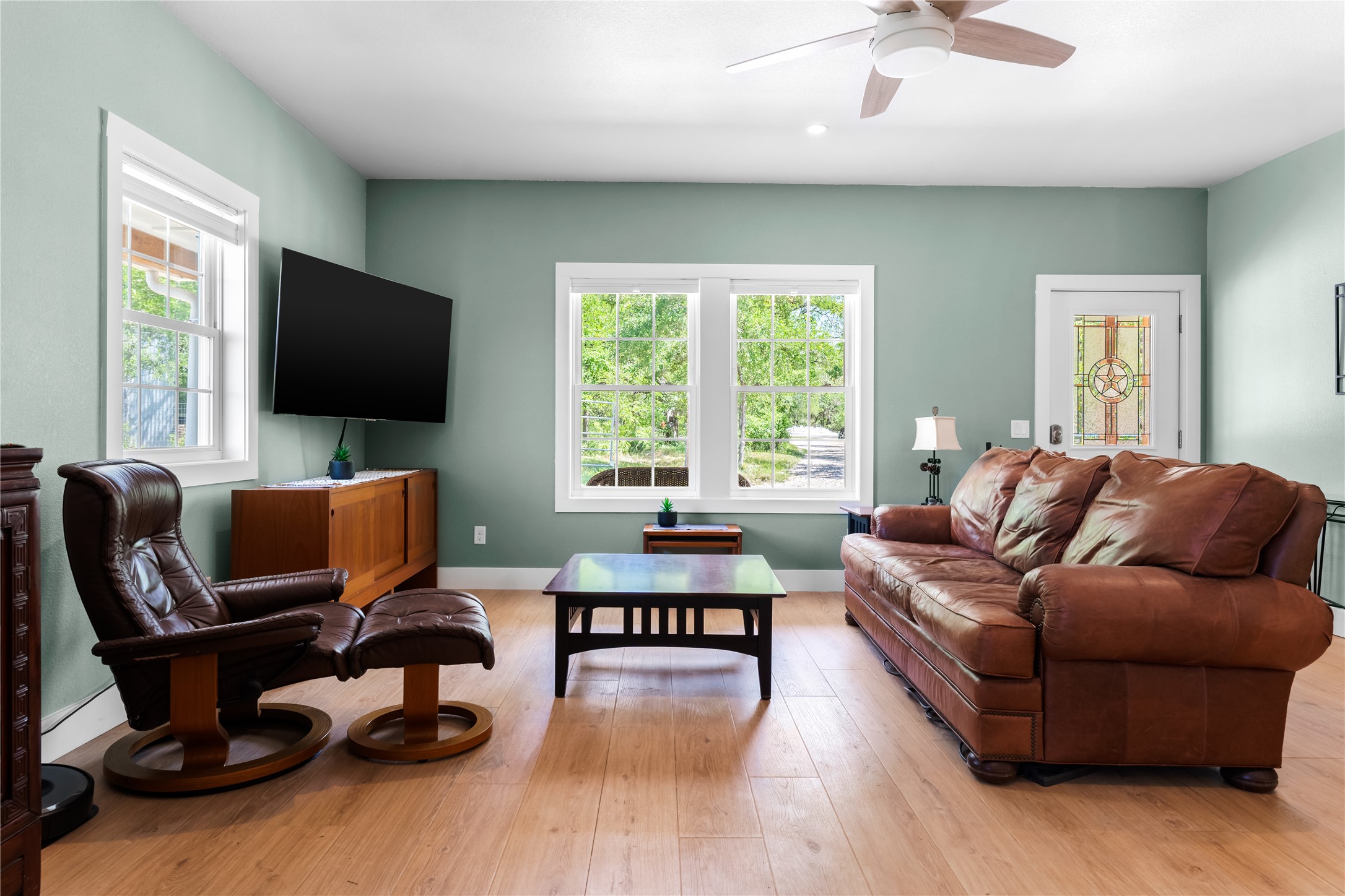 7670 Nez Perce Trace Manor, TX 78653 - Photo 22 of 40 Living area with baseboards, a ceiling fan, and light wood finished floors