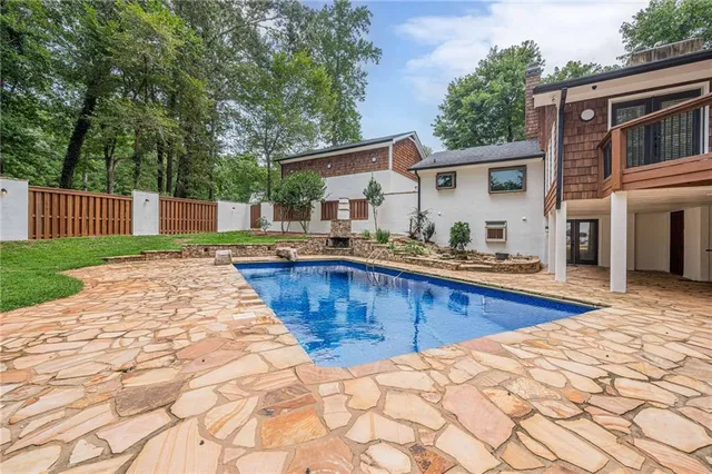 a swimming pool with outdoor seating and yard
