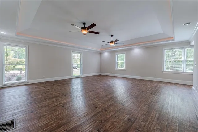 a view of wooden floor and windows in a room