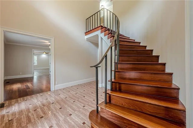 a view of entryway and hall with wooden floor