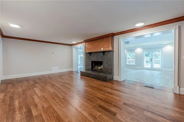 wooden floor in an empty room with a fireplace