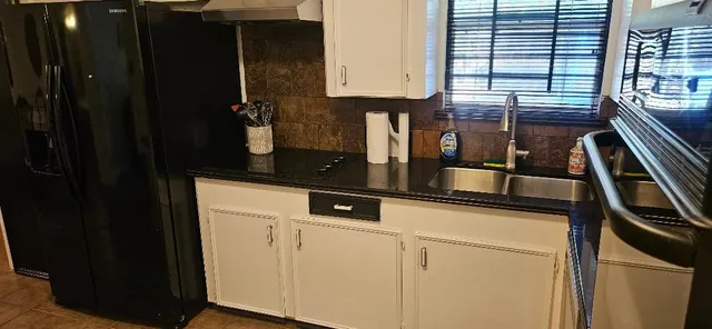 a kitchen with a sink and cabinets