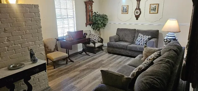 a living room with furniture and a lamp