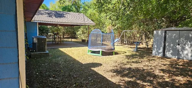 a view of a backyard with sitting area