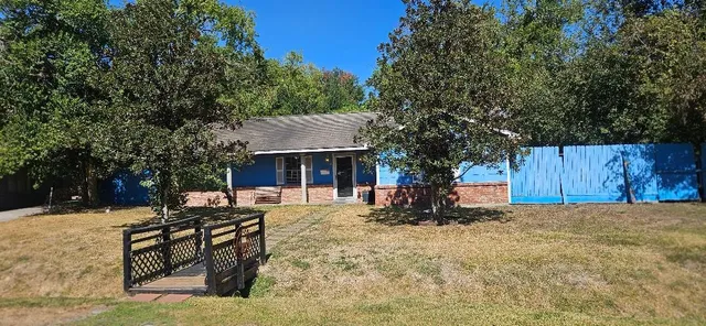 a view of a house with a yard covered in snow