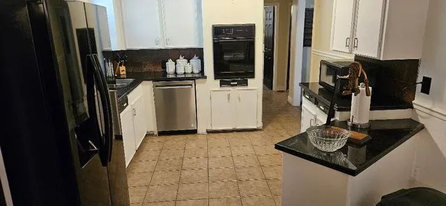 a view of a kitchen with appliances and cabinets