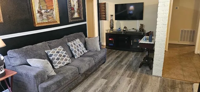 a living room with furniture and a flat screen tv