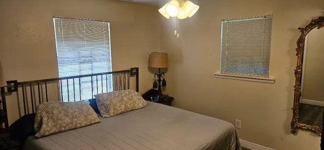 a bedroom with a bed and a chandelier