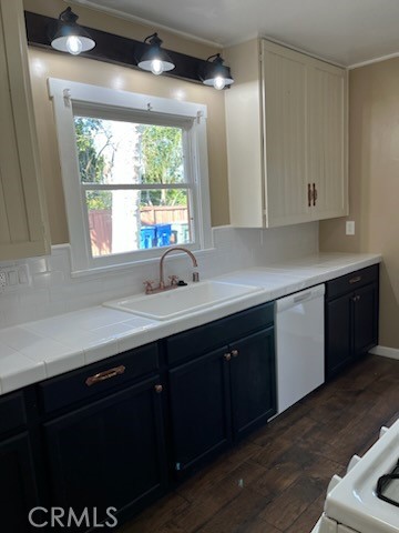 4036 Adams Street Riverside, CA 92504 - Photo 2 of 8 a kitchen with a sink window and cabinets