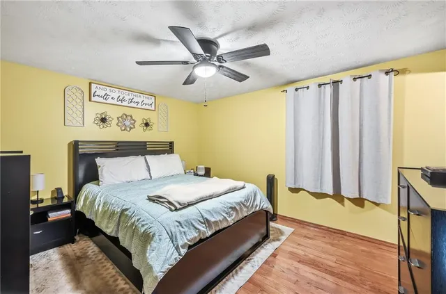 a bedroom with a bed and a window