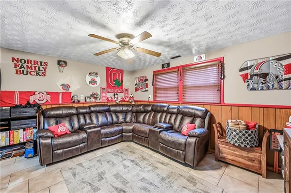 a living room with furniture a rug and a wall painting