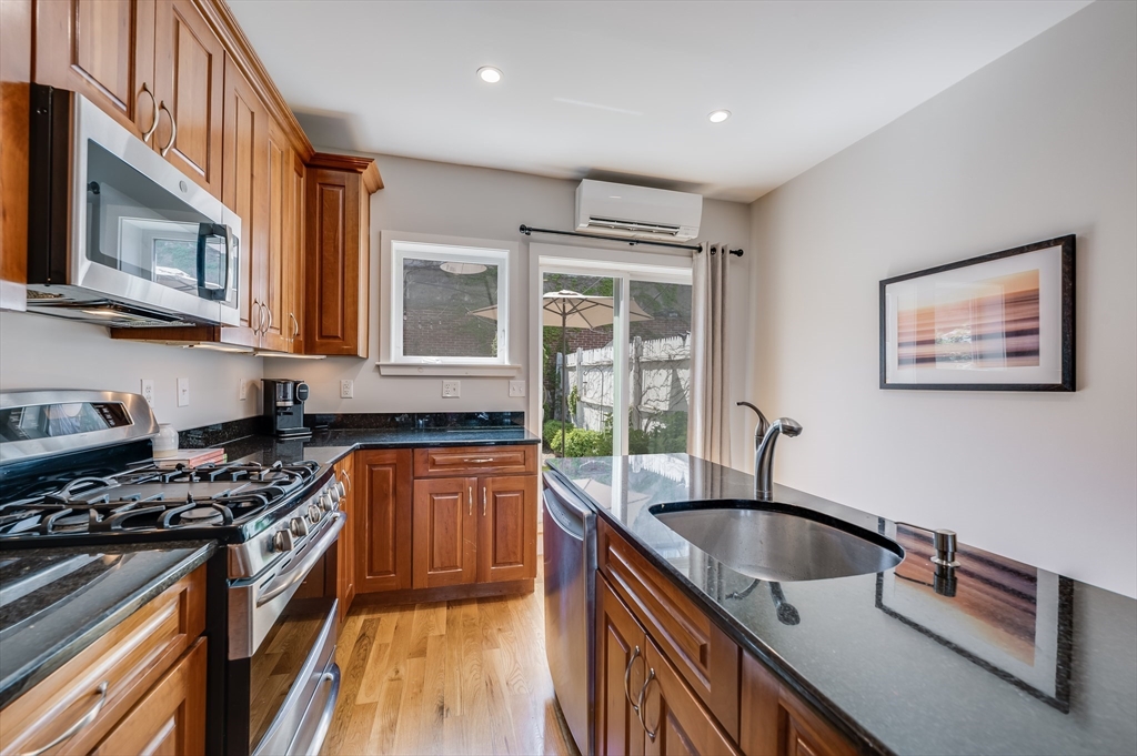 39 Emerson Street Boston, MA 02127 - Photo 9 of 20 a kitchen with stainless steel appliances granite countertop a sink stove and cabinets