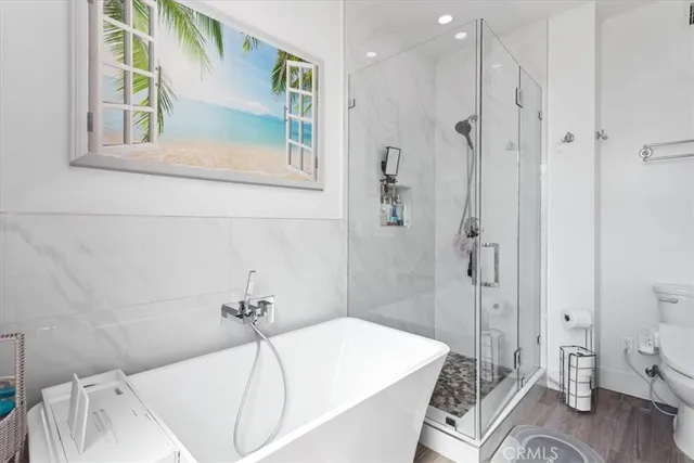 a bathroom with a tub a sink and a shower