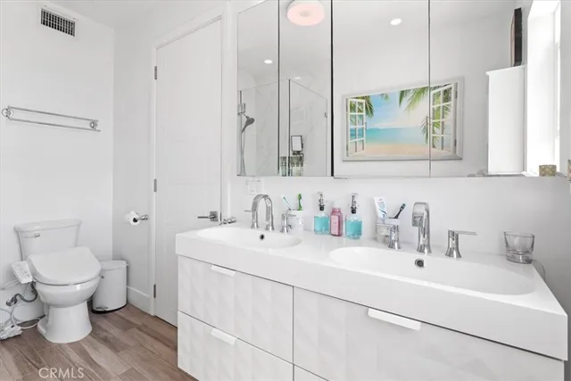 a bathroom with a sink toilet and a mirror