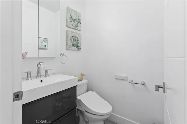 a bathroom with a toilet a sink and mirror