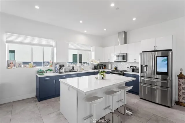 a kitchen with a sink a counter top stainless steel appliances and cabinets