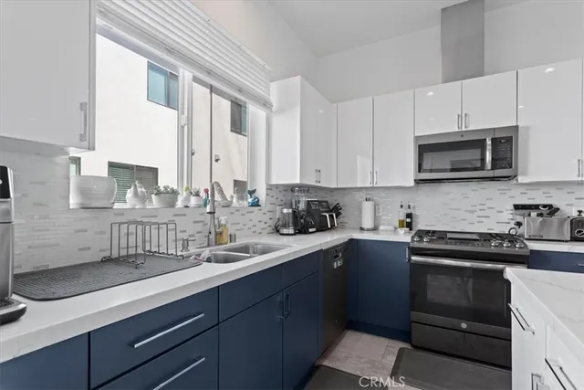 a kitchen with a sink stove and microwave