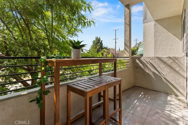 a balcony with a table and chairs