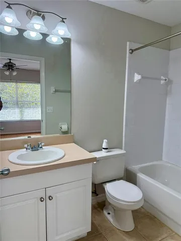a bathroom with a sink toilet vanity and shower
