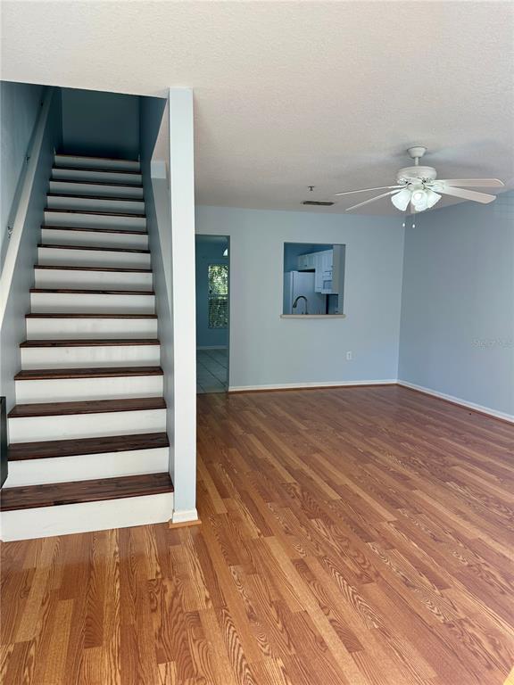 2636 Southwest 35th Place, Unit 21 Gainesville, FL 32608 - Photo 2 of 16 a view of a room with stairs and wooden floor
