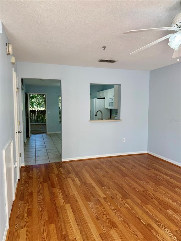 2636 Southwest 35th Place, Unit 21 Gainesville, FL 32608 - Photo 3 of 16 a view of a room with wooden floor and a bathroom