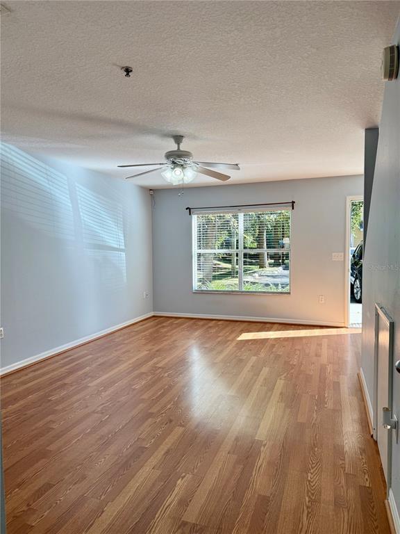 2636 Southwest 35th Place, Unit 21 Gainesville, FL 32608 - Photo 4 of 16 wooden floor in an empty room with a window
