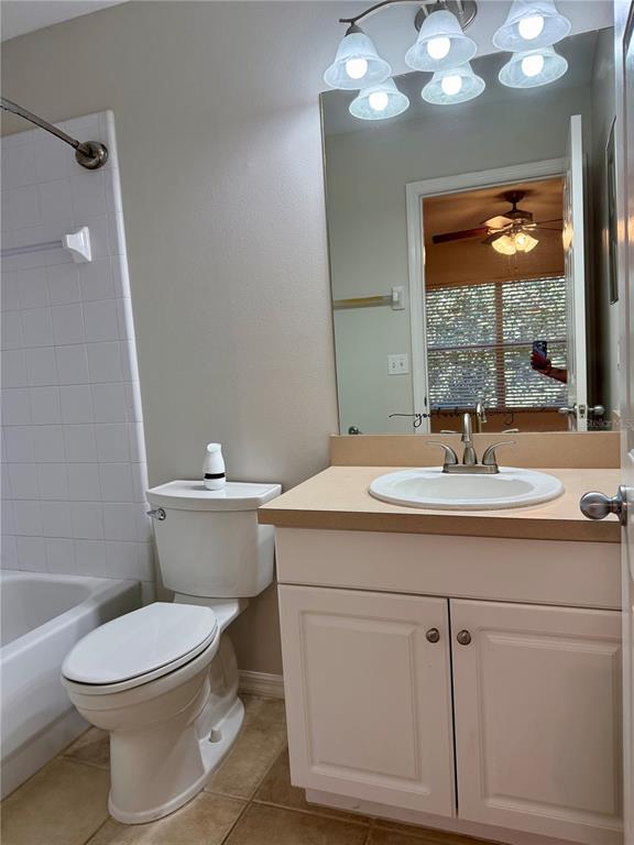 2636 Southwest 35th Place, Unit 21 Gainesville, FL 32608 - Photo 10 of 16 a bathroom with a sink a toilet and a mirror