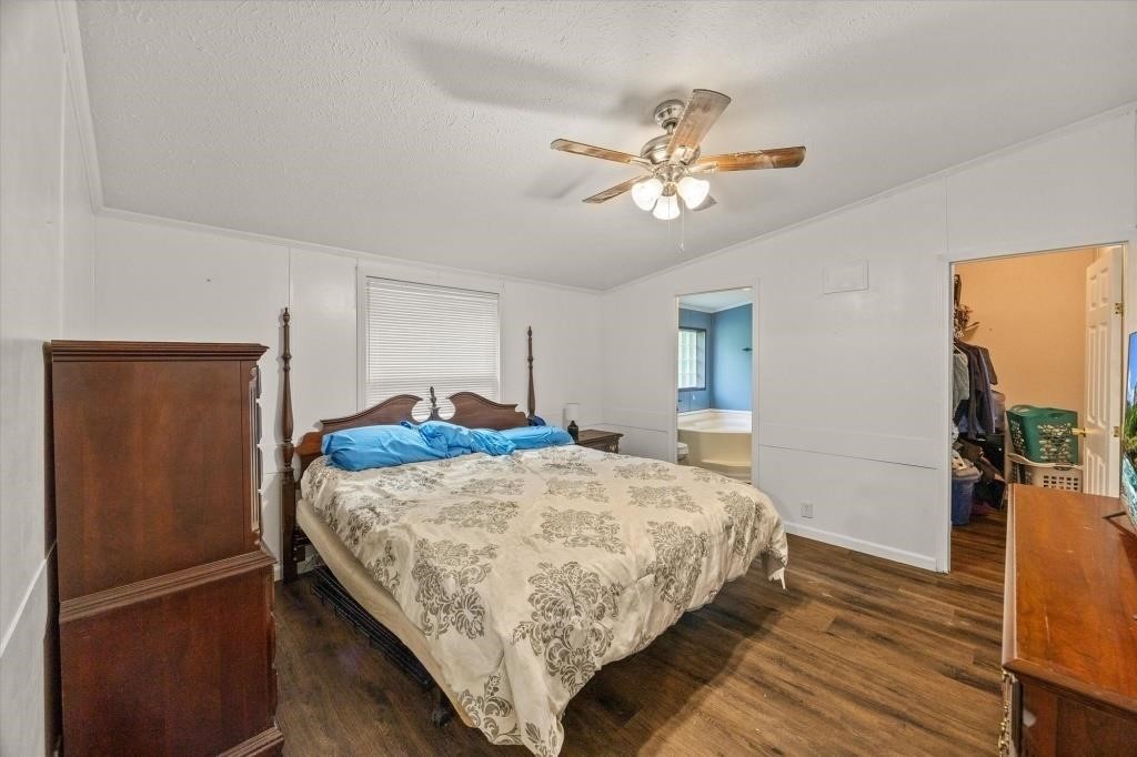 938 Riley Creek Road Whitleyville, TN 38588 - Photo 13 of 40 a bedroom with a bed and wooden floor