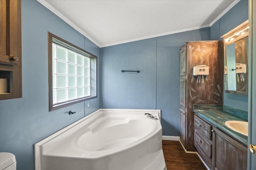 938 Riley Creek Road Whitleyville, TN 38588 - Photo 15 of 40 a bathroom with a bathtub and a sink