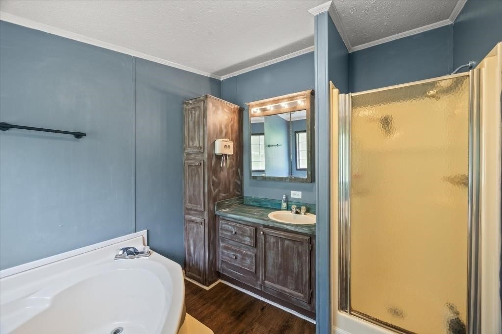 938 Riley Creek Road Whitleyville, TN 38588 - Photo 16 of 40 a en suite bathroom with a sink mirror and shower