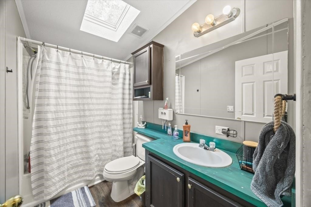 938 Riley Creek Road Whitleyville, TN 38588 - Photo 19 of 40 a bathroom with a sink a toilet and shower