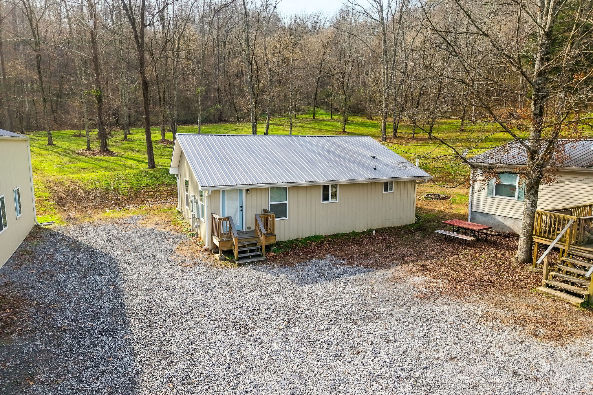 938 Riley Creek Road Whitleyville, TN 38588 - Photo 23 of 40 a view of a house with backyard and a tree