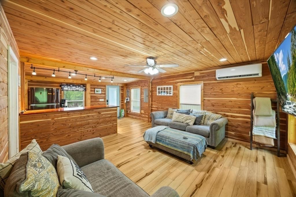 938 Riley Creek Road Whitleyville, TN 38588 - Photo 27 of 40 a living room with furniture and wooden floor