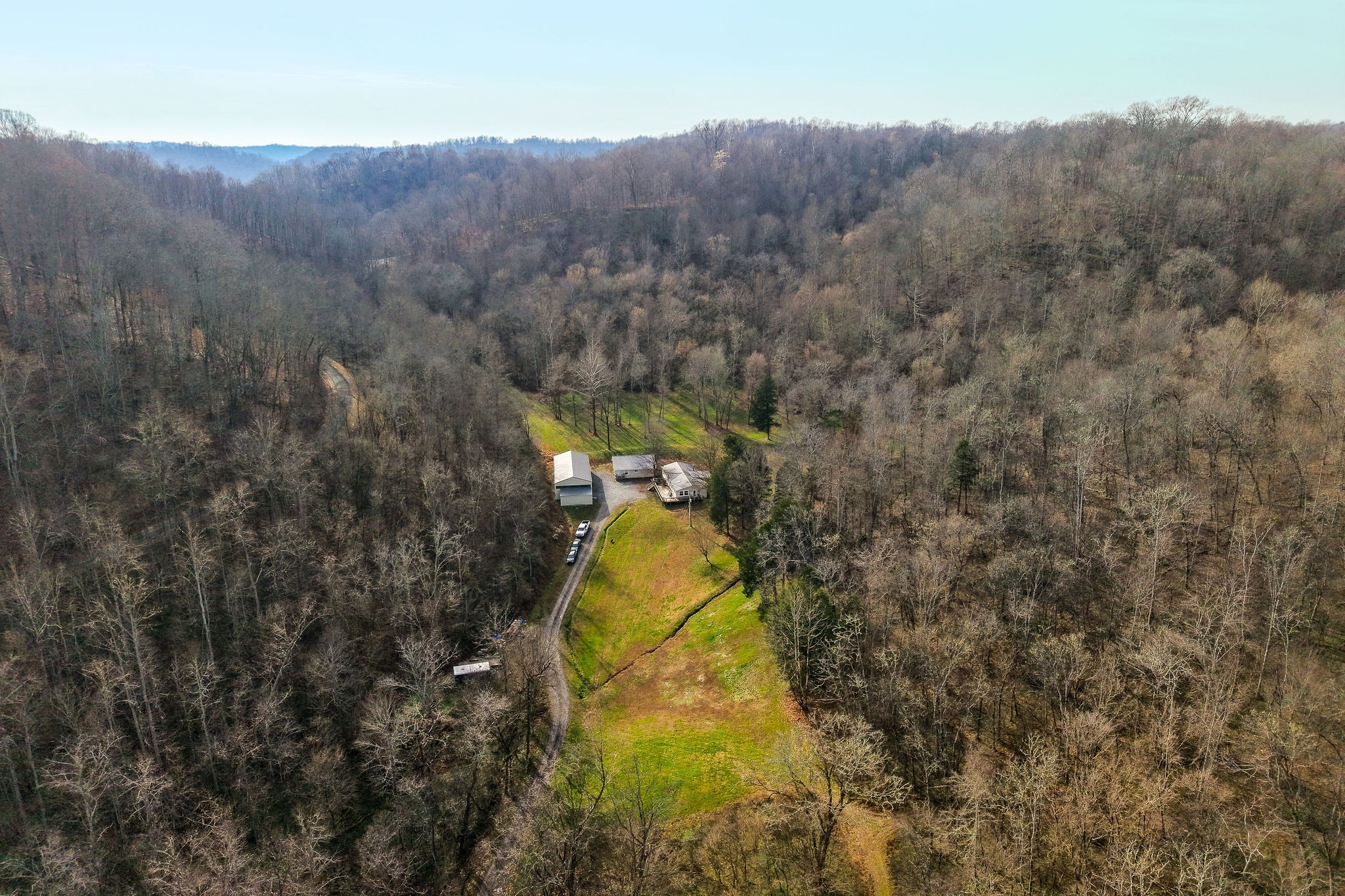938 Riley Creek Road Whitleyville, TN 38588 - Photo 3 of 40 a aerial view of a house with swimming pool and mountain view