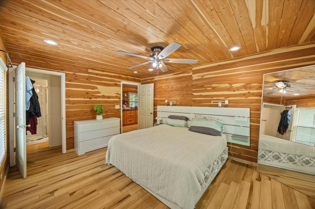 938 Riley Creek Road Whitleyville, TN 38588 - Photo 32 of 40 a view of a bedroom with wooden floor