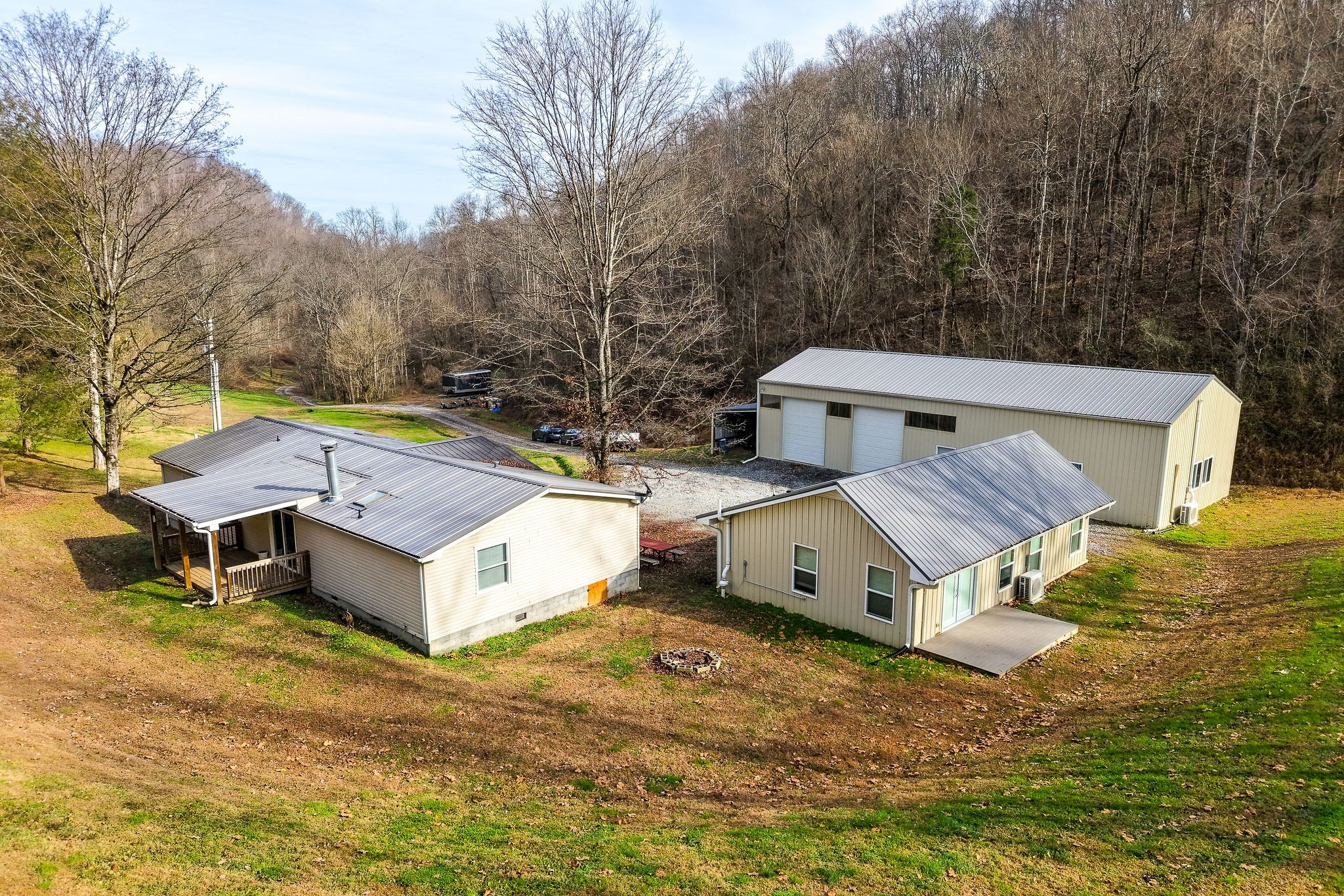 938 Riley Creek Road Whitleyville, TN 38588 - Photo 4 of 40 an aerial view of a house with a yard and deck
