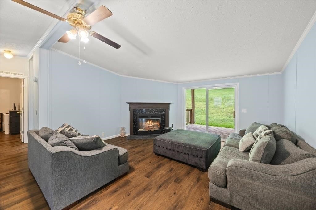 938 Riley Creek Road Whitleyville, TN 38588 - Photo 7 of 40 a living room with furniture and a fireplace