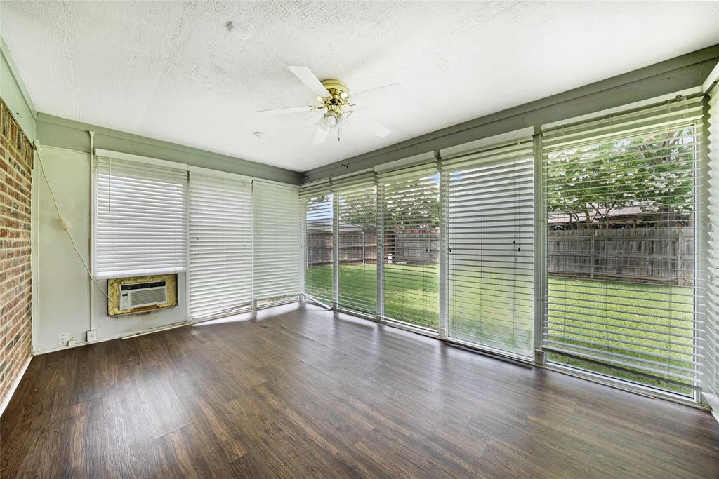 2910 Chisholm Trail Corinth, TX 76210 - Photo 26 of 30 an empty room with wooden floor and windows