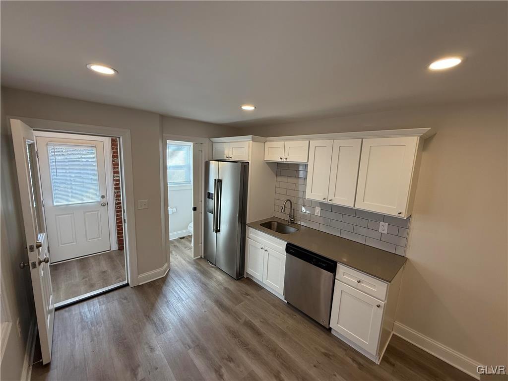 32 Easton Road Nazareth, PA 18064 - Photo 14 of 47 a kitchen with stainless steel appliances granite countertop a refrigerator a sink dishwasher a stove and white countertops with wooden floor
