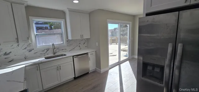 a kitchen with a sink and refrigerator
