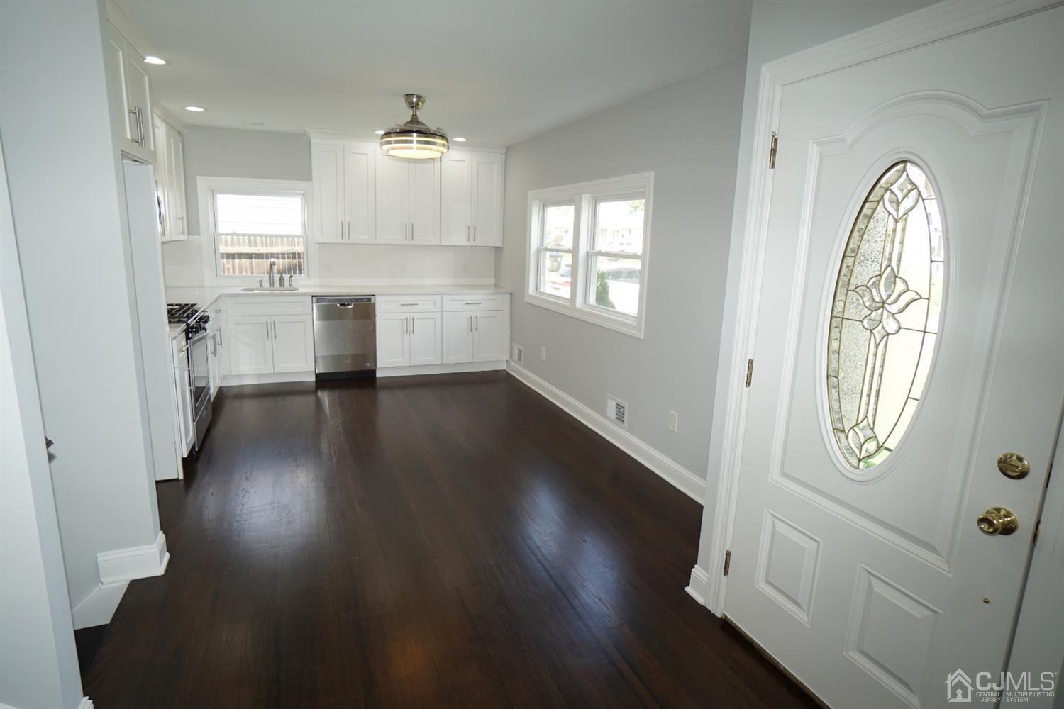 69 Albemarle Road Colonia, NJ 07067 - Photo 14 of 40 an empty room with wooden floor mirror and windows
