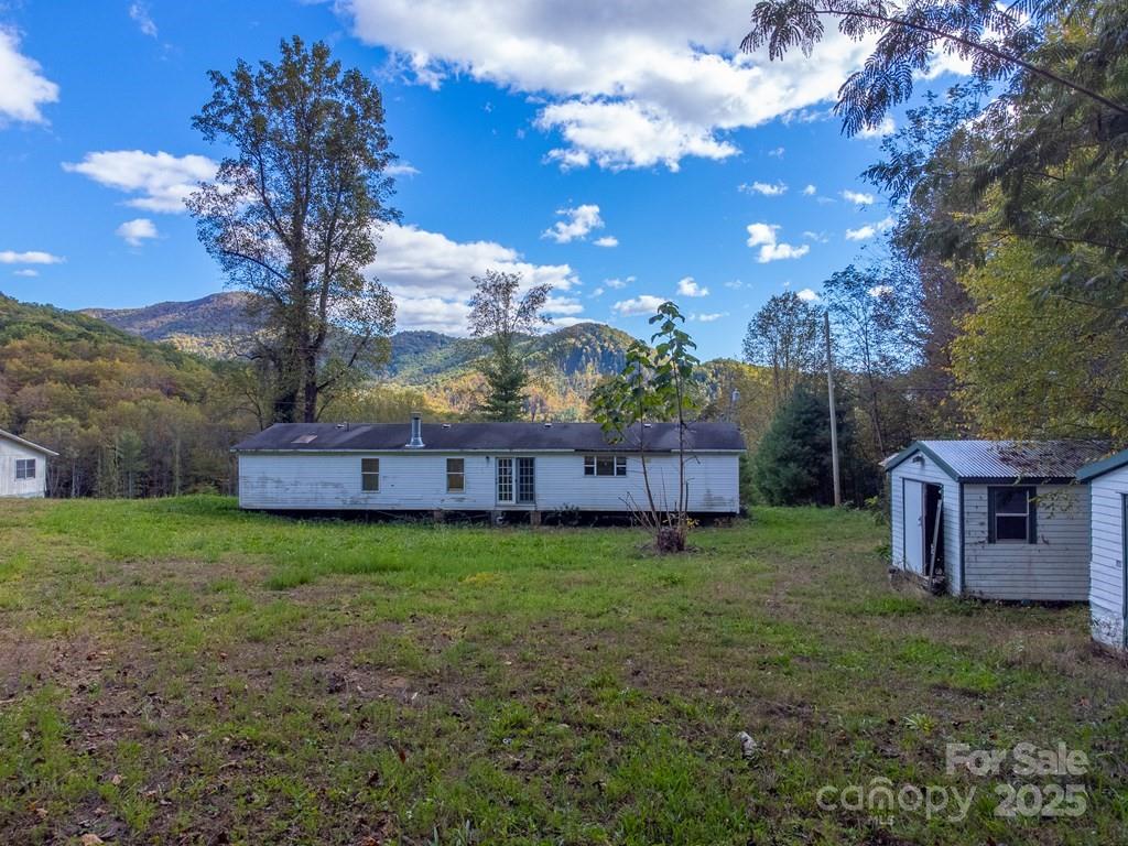 8125 Ellijay Road Franklin, NC 28734 - Photo 35 of 35 a view of a house with backyard and garden