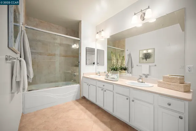 a bathroom with a double vanity sink and a mirror