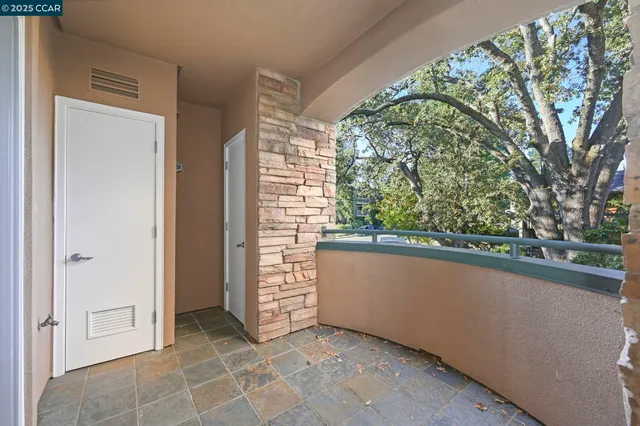 a balcony with table and chairs