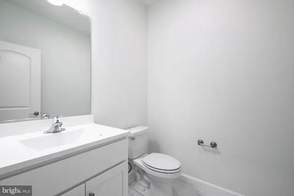 a bathroom with a sink toilet and a mirror