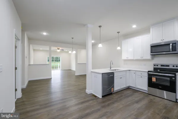 a large kitchen with stainless steel appliances granite countertop a stove and a sink