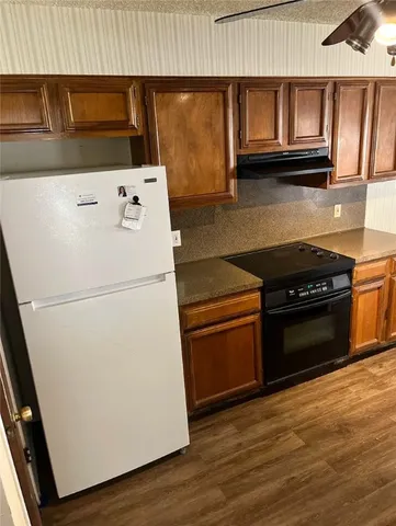 a kitchen with granite countertop a stove and a microwave
