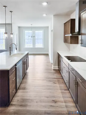 a kitchen with stainless steel appliances granite countertop a sink and a wooden floors